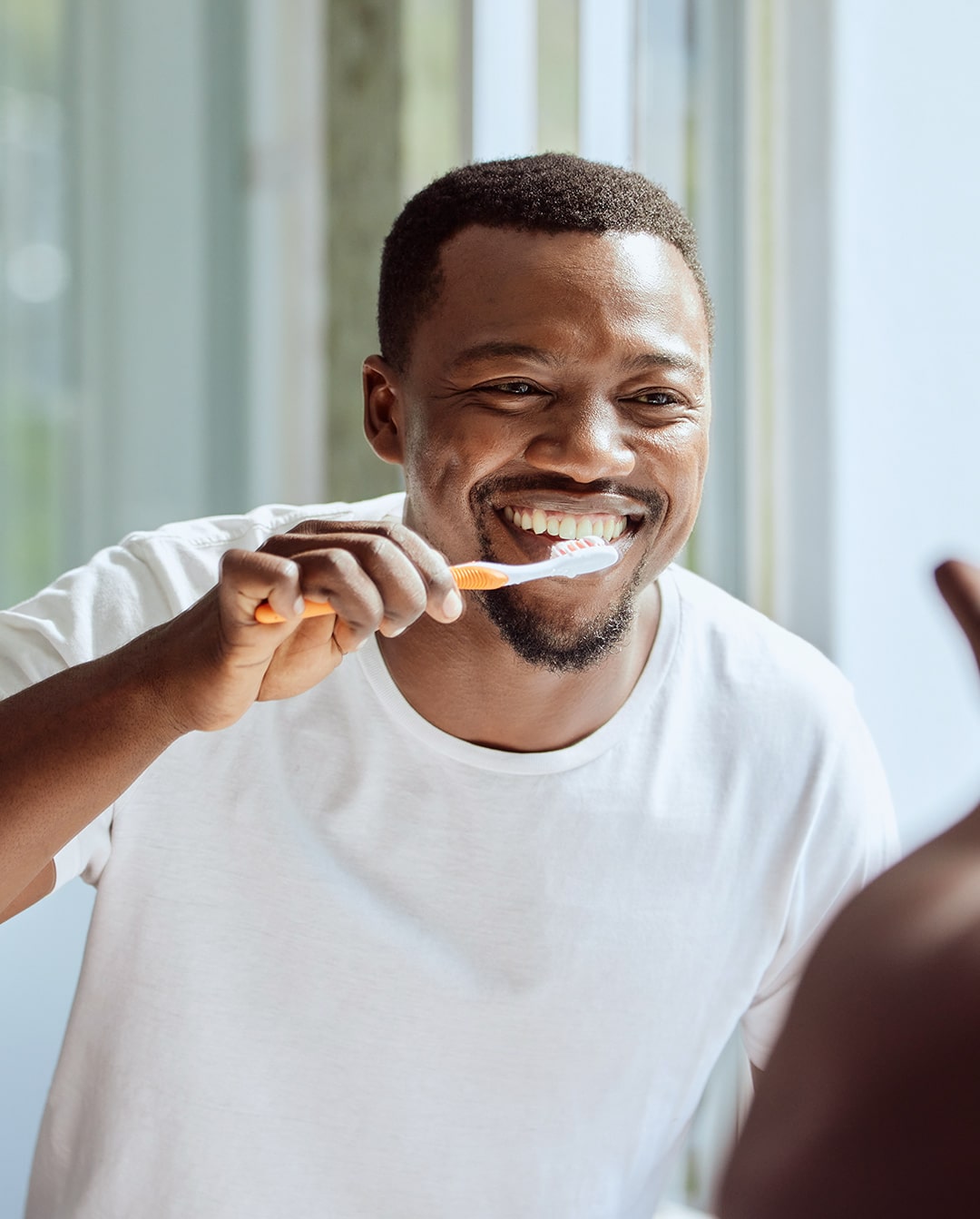 A man smiling and brushing his teeth in powder springs gA