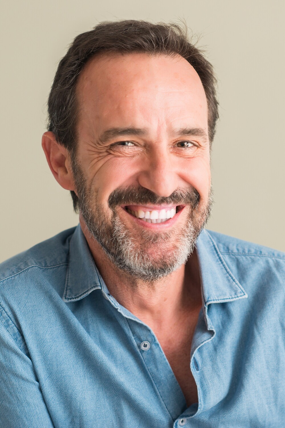 Man showing the camera his single tooth replacement in GA