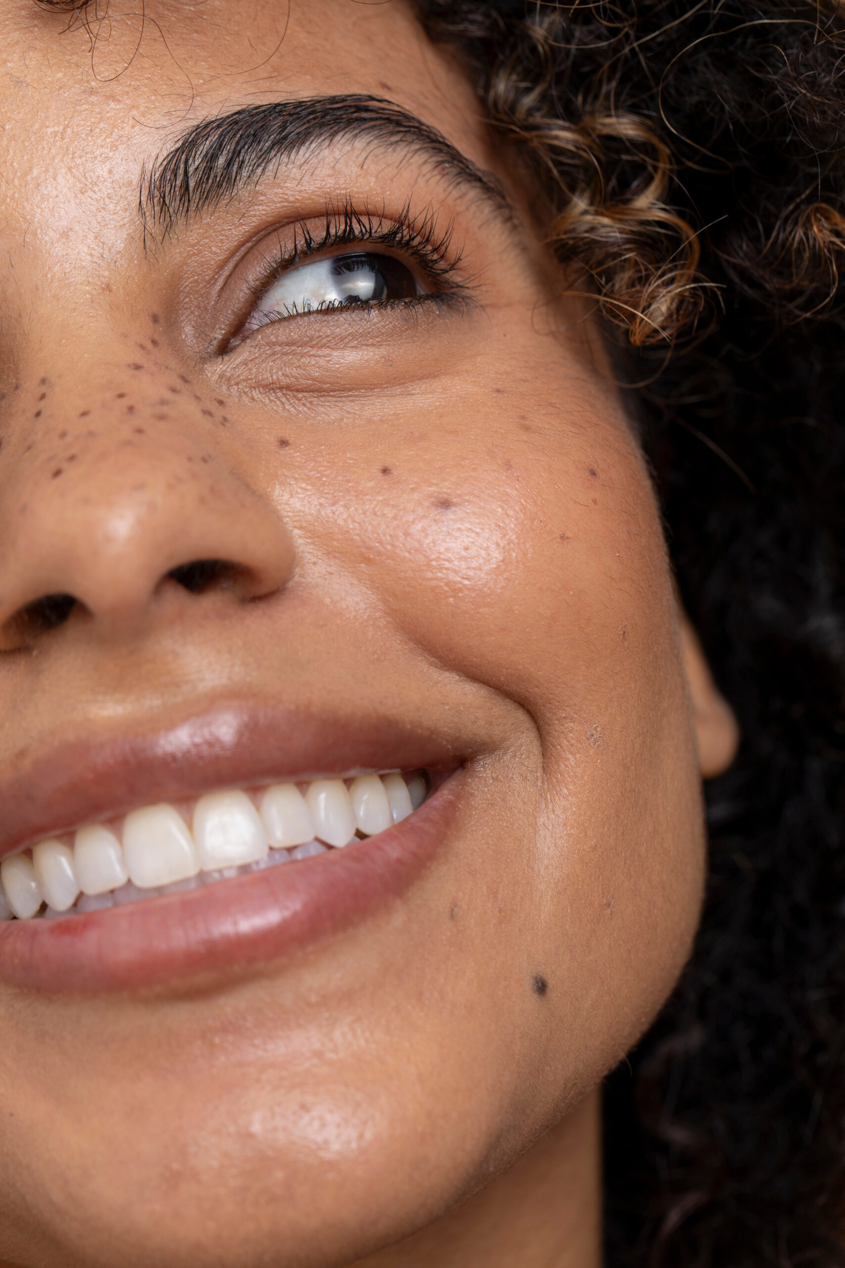 Smiling woman with brown eyes and freckles